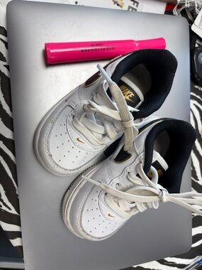 Nike Kids White Sneakers with Black Collar and Gold Swoosh